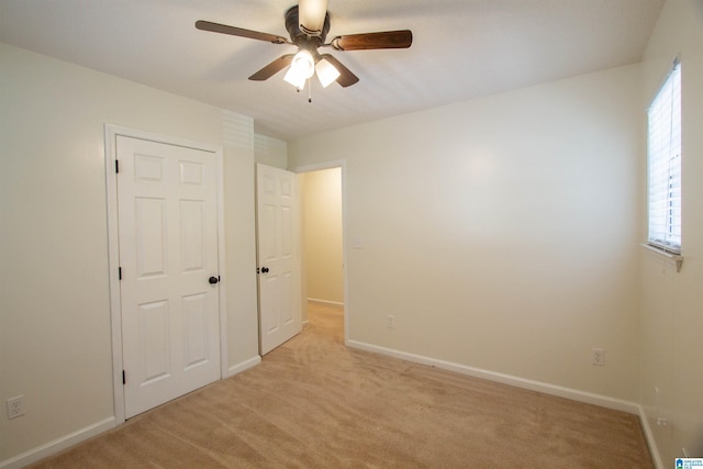 1725 Faircrest Dr, Hueytown, AL 35023 - unfurnished bedroom with multiple windows, light carpet, baseboards, and ceiling fan