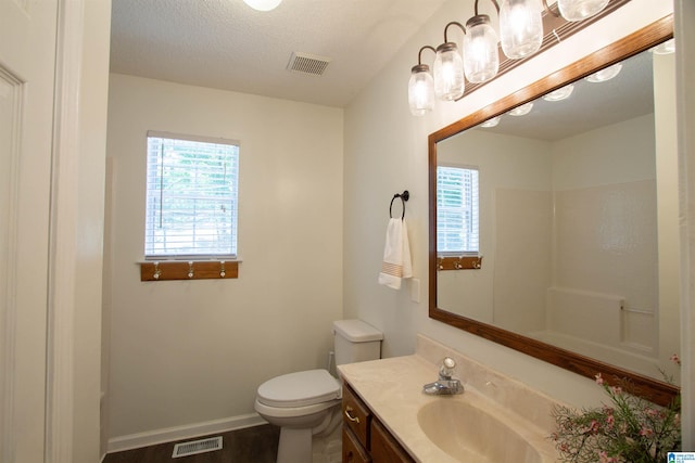 1725 Faircrest Dr, Hueytown, AL 35023 - full bathroom featuring toilet, vanity, baseboards, wood finished floors, and a textured ceiling
