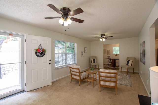 1725 Faircrest Dr, Hueytown, AL 35023 - living room with ceiling fan, light carpet, baseboards, and a textured ceiling
