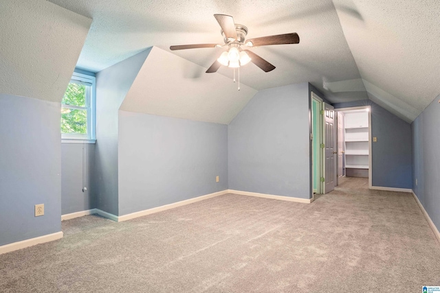 295 Walden Ct, Montevallo, AL 35115 - additional living space with a textured ceiling, vaulted ceiling, carpet floors, a ceiling fan, and baseboards