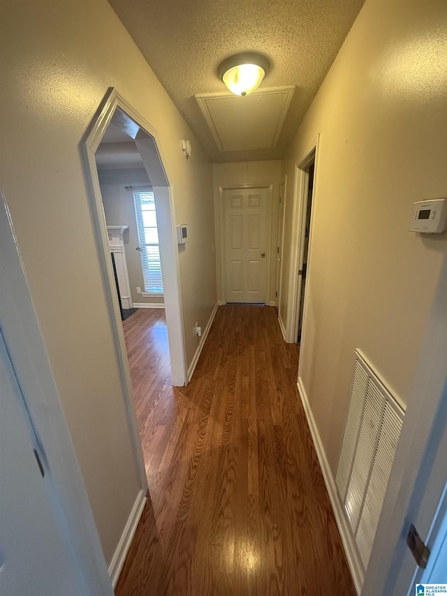 18470 Whispering Meadows Blvd, Vance, AL 35490 - hallway featuring attic access, wood finished floors, a textured ceiling, and baseboards