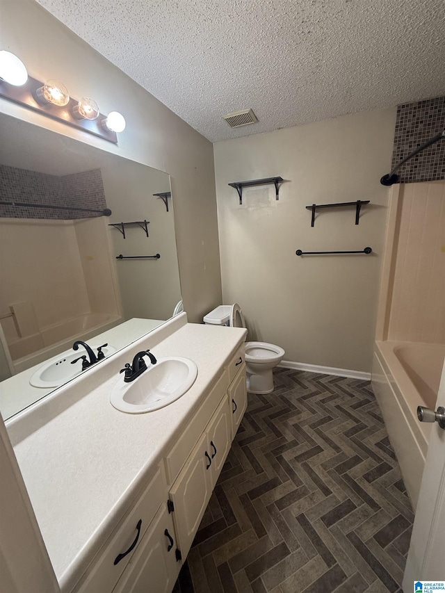 18470 Whispering Meadows Blvd, Vance, AL 35490 - bathroom featuring vanity, a textured ceiling, toilet, and shower / bathtub combination