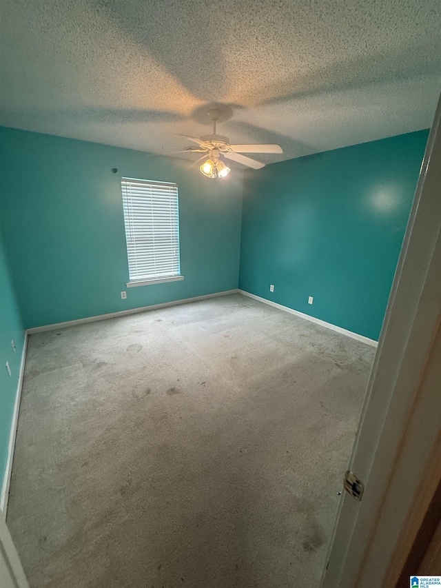 18470 Whispering Meadows Blvd, Vance, AL 35490 - spare room with carpet flooring, a textured ceiling, ceiling fan, and baseboards