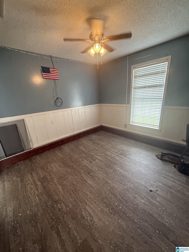 18470 Whispering Meadows Blvd, Vance, AL 35490 - empty room featuring wainscoting, a textured ceiling, dark wood-style floors, and ceiling fan