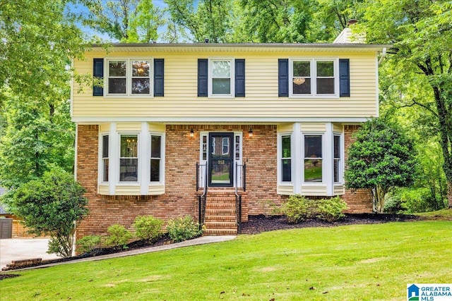 113 Pine Cliff Cir, Hoover, AL 35226 - colonial home featuring a front lawn, brick siding, and a chimney