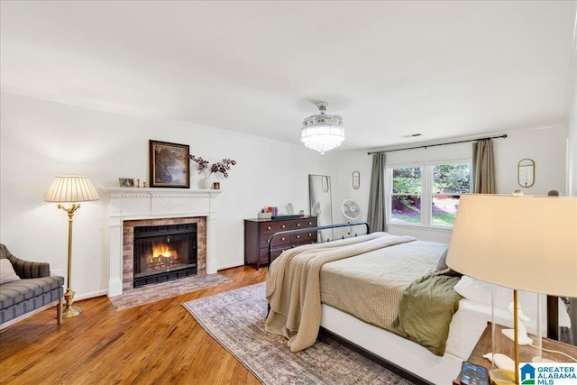 113 Pine Cliff Cir, Hoover, AL 35226 - bedroom featuring a fireplace with flush hearth, wood finished floors, and crown molding