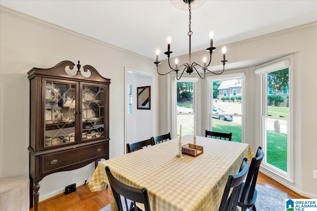 113 Pine Cliff Cir, Hoover, AL 35226 - dining area with a chandelier, crown molding, and wood finished floors