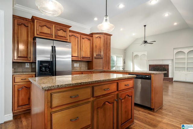 295 Ridge View Way, Springville, AL 35146 - kitchen with stainless steel appliances, a kitchen island, ceiling fan, decorative backsplash, and lofted ceiling
