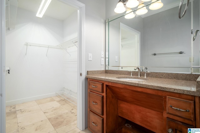 295 Ridge View Way, Springville, AL 35146 - bathroom with vanity, a walk in closet, and baseboards