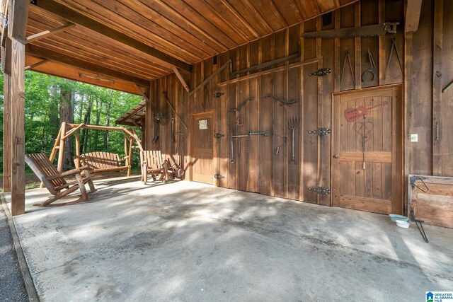 295 Ridge View Way, Springville, AL 35146 - misc room with unfinished concrete flooring, wood walls, and wooden ceiling
