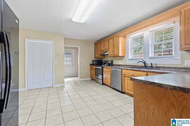 114NW Morgan Ave, Cullman, AL 35055 - kitchen with a sink, black appliances, dark countertops, under cabinet range hood, and a textured ceiling