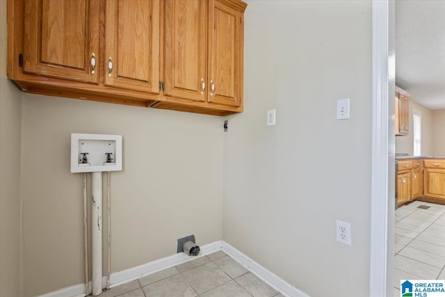 114NW Morgan Ave, Cullman, AL 35055 - laundry area featuring washer hookup, cabinet space, light tile patterned flooring, and baseboards