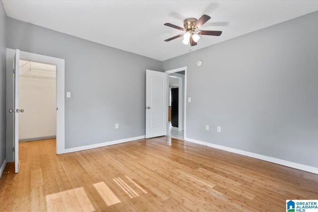 114NW Morgan Ave, Cullman, AL 35055 - unfurnished bedroom featuring a spacious closet, light wood-style floors, baseboards, a ceiling fan, and a closet