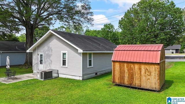 114NW Morgan Ave, Cullman, AL 35055 - rear view of house featuring central air condition unit, a patio area, and a lawn
