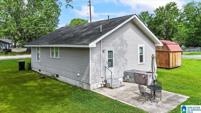 114NW Morgan Ave, Cullman, AL 35055 - rear view of property with crawl space, entry steps, a shingled roof, a lawn, and a patio area