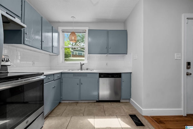 4763 7th Ct S, Birmingham, AL 35222 - kitchen featuring appliances with stainless steel finishes, a sink, range hood, gray cabinets, and decorative backsplash