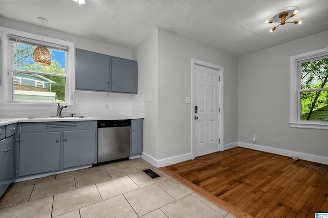 4763 7th Ct S, Birmingham, AL 35222 - kitchen with dishwasher, a sink, gray cabinetry, light countertops, and a textured ceiling