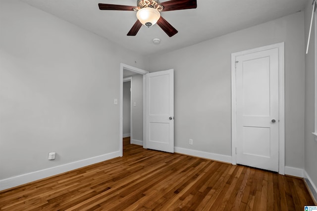 4763 7th Ct S, Birmingham, AL 35222 - unfurnished bedroom with wood finished floors, baseboards, and ceiling fan