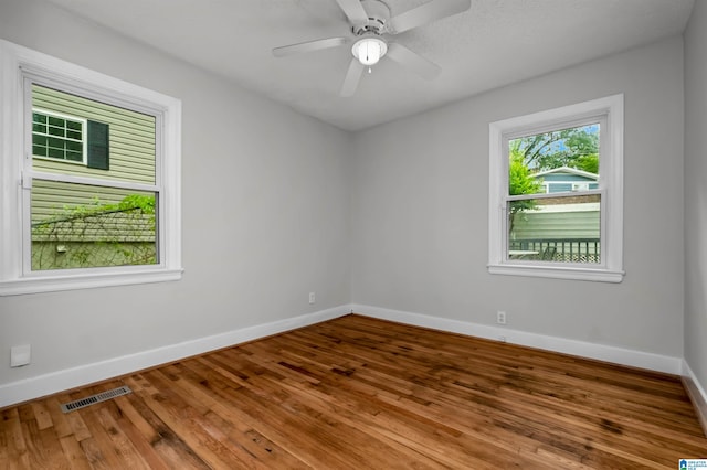 4763 7th Ct S, Birmingham, AL 35222 - spare room featuring baseboards, wood finished floors, and a ceiling fan
