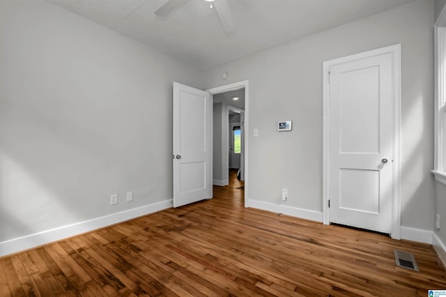 4763 7th Ct S, Birmingham, AL 35222 - unfurnished bedroom featuring hardwood / wood-style floors, baseboards, and a ceiling fan