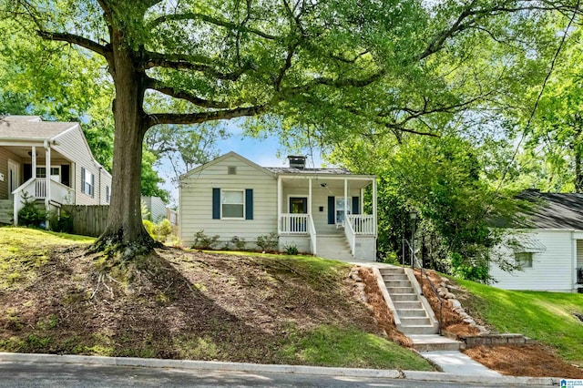 4763 7th Ct S, Birmingham, AL 35222 - view of front facade featuring stairs, covered porch, and a chimney