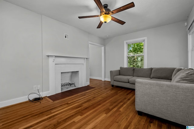 4763 7th Ct S, Birmingham, AL 35222 - living room featuring a ceiling fan, wood finished floors, baseboards, and a tiled fireplace