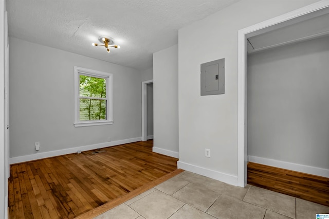 4763 7th Ct S, Birmingham, AL 35222 - unfurnished room with electric panel, baseboards, light tile patterned flooring, and a textured ceiling