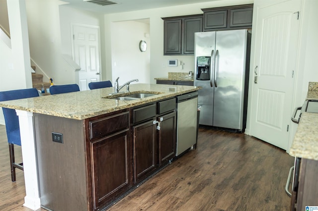 222 Sarah Way, Kimberly, AL 35091 - kitchen featuring appliances with stainless steel finishes, a kitchen bar, dark wood-style floors, light stone countertops, and a sink