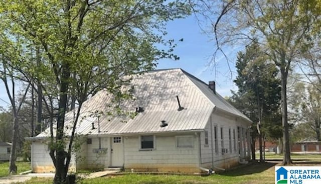 1711 5th Ave N, Bessemer, AL 35020 - view of side of home featuring metal roof and a lawn