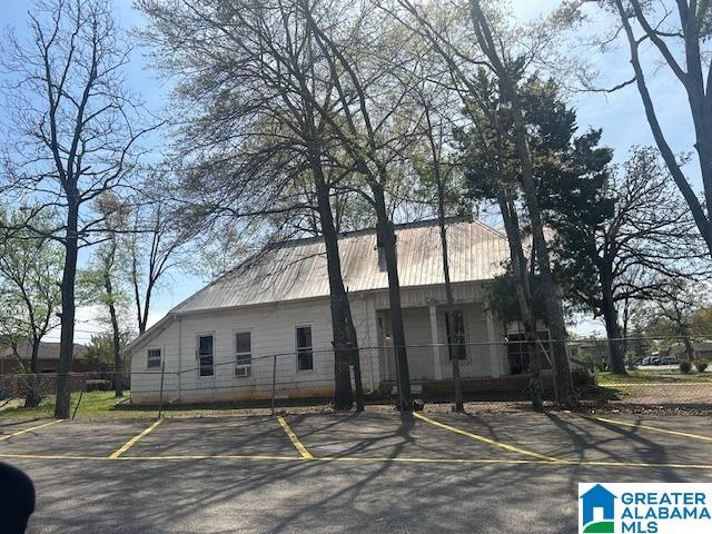 1711 5th Ave N, Bessemer, AL 35020 - view of side of home featuring uncovered parking and metal roof