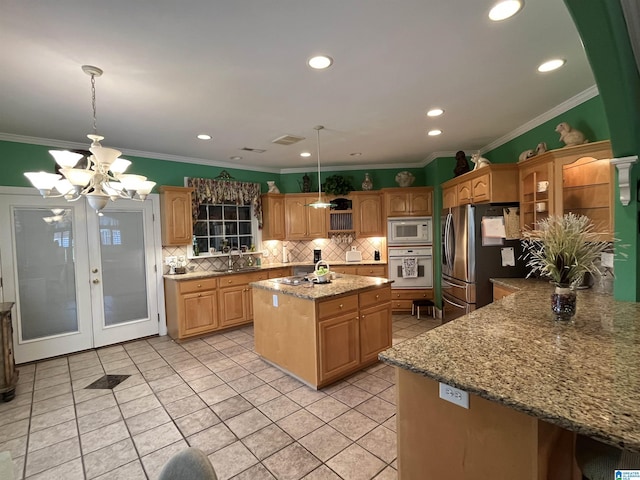 50 Ashton Ln, Sylacauga, AL 35150 - kitchen featuring oven, built in microwave, freestanding refrigerator, tasteful backsplash, and a center island