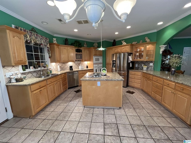 50 Ashton Ln, Sylacauga, AL 35150 - kitchen with a sink, appliances with stainless steel finishes, backsplash, arched walkways, and a center island