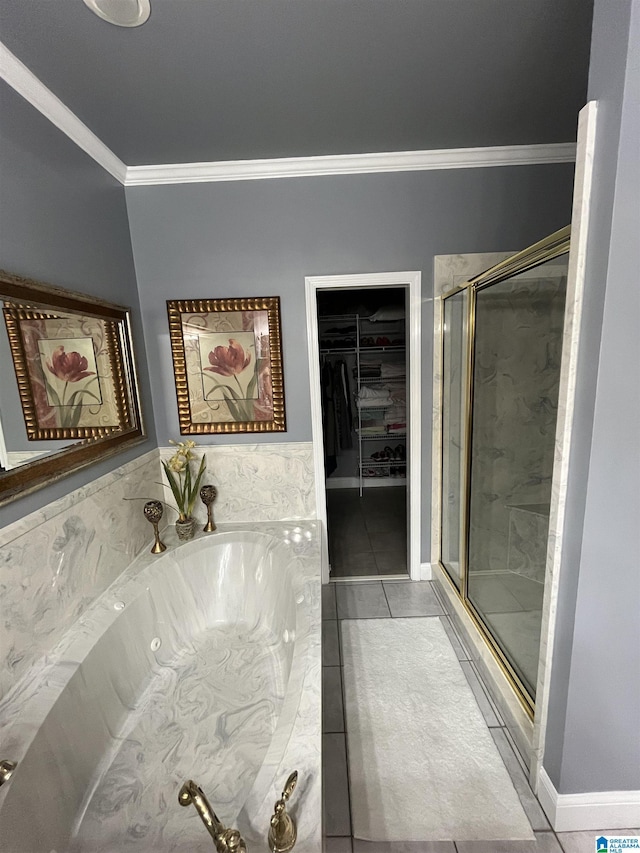 50 Ashton Ln, Sylacauga, AL 35150 - full bath featuring ornamental molding, a stall shower, a garden tub, a walk in closet, and tile patterned floors
