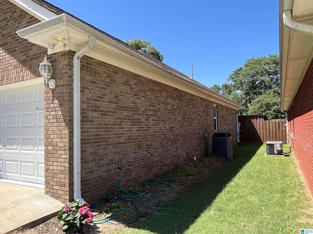 50 Ashton Ln, Sylacauga, AL 35150 - view of side of property featuring central AC unit, an attached garage, and brick siding