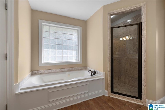 255 Savannah Ln, Cleveland, AL 35049 - full bath featuring a bath, a stall shower, and wood finished floors