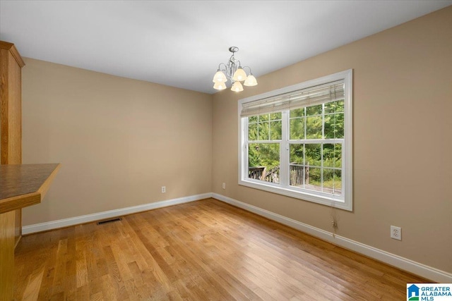 255 Savannah Ln, Cleveland, AL 35049 - unfurnished room featuring a chandelier, baseboards, and light wood finished floors