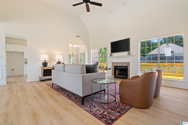 773 Old Cahaba Dr, Helena, AL 35080 - living room with a tiled fireplace, a ceiling fan, light wood-style floors, plenty of natural light, and high vaulted ceiling
