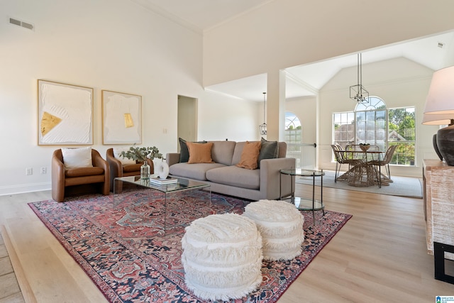 773 Old Cahaba Dr, Helena, AL 35080 - living room with light wood-type flooring, high vaulted ceiling, a chandelier, and baseboards