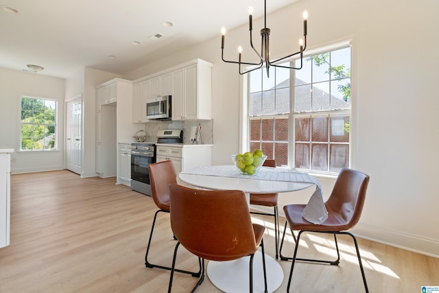 773 Old Cahaba Dr, Helena, AL 35080 - dining area featuring light wood-type flooring, a chandelier, baseboards, and plenty of natural light