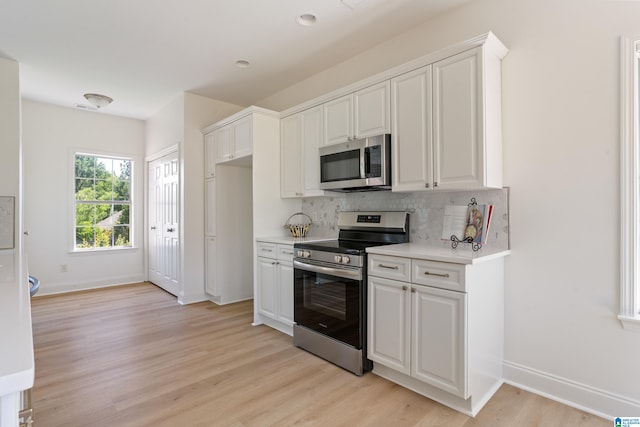 773 Old Cahaba Dr, Helena, AL 35080 - kitchen featuring appliances with stainless steel finishes, backsplash, baseboards, light wood-type flooring, and light countertops