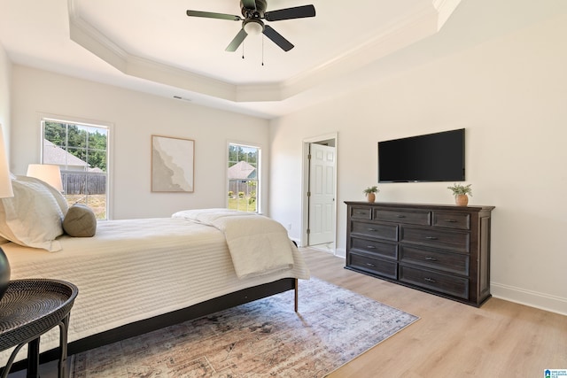 773 Old Cahaba Dr, Helena, AL 35080 - bedroom featuring ornamental molding, a raised ceiling, light wood finished floors, baseboards, and a ceiling fan