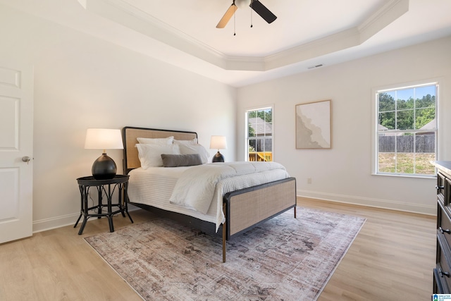 773 Old Cahaba Dr, Helena, AL 35080 - bedroom with crown molding, a tray ceiling, light wood finished floors, baseboards, and a ceiling fan