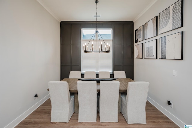 4651 Silas Ave, Hoover, AL 35244 - dining space featuring crown molding, a chandelier, baseboards, and light wood-type flooring