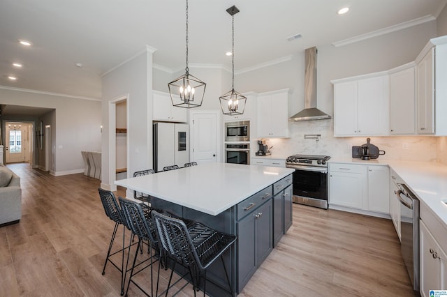 4651 Silas Ave, Hoover, AL 35244 - kitchen featuring stainless steel appliances, wall chimney exhaust hood, ornamental molding, white cabinetry, and recessed lighting
