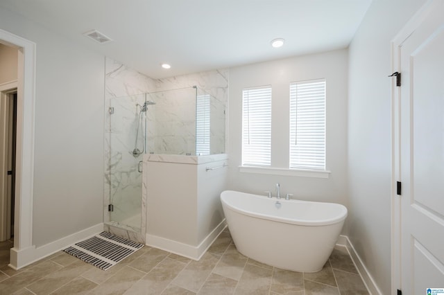 4651 Silas Ave, Hoover, AL 35244 - bathroom featuring a marble finish shower, a freestanding bath, and baseboards