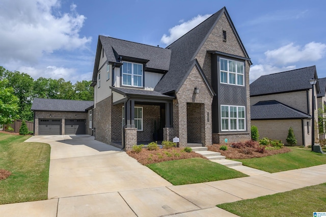 4651 Silas Ave, Hoover, AL 35244 - view of front facade featuring a front yard, a shingled roof, a garage, and brick siding