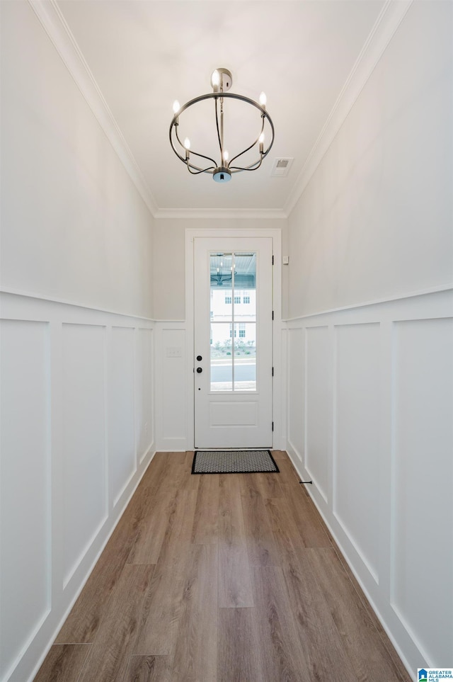 4651 Silas Ave, Hoover, AL 35244 - doorway to outside with a chandelier, a decorative wall, ornamental molding, wood finished floors, and wainscoting