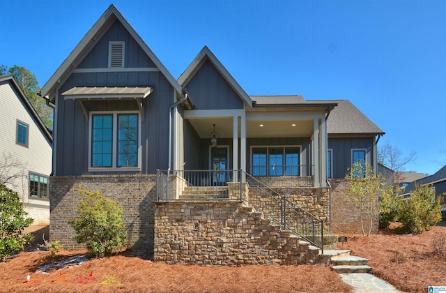 112 Perry Pl, Birmingham, AL 35242 - view of front facade with board and batten siding, stairs, a porch, and brick siding