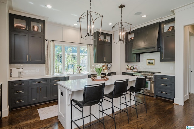 112 Perry Pl, Birmingham, AL 35242 - kitchen featuring high end range, custom exhaust hood, light countertops, a sink, and tasteful backsplash