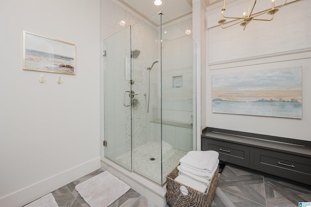 112 Perry Pl, Birmingham, AL 35242 - bathroom with a shower stall, a chandelier, and baseboards